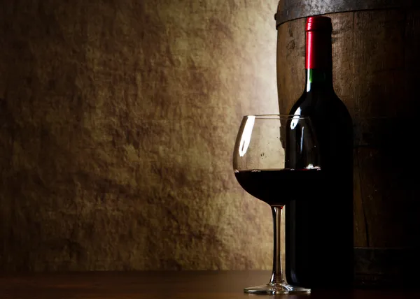 Red wine, bottle, glass and old barrel Stock Photo