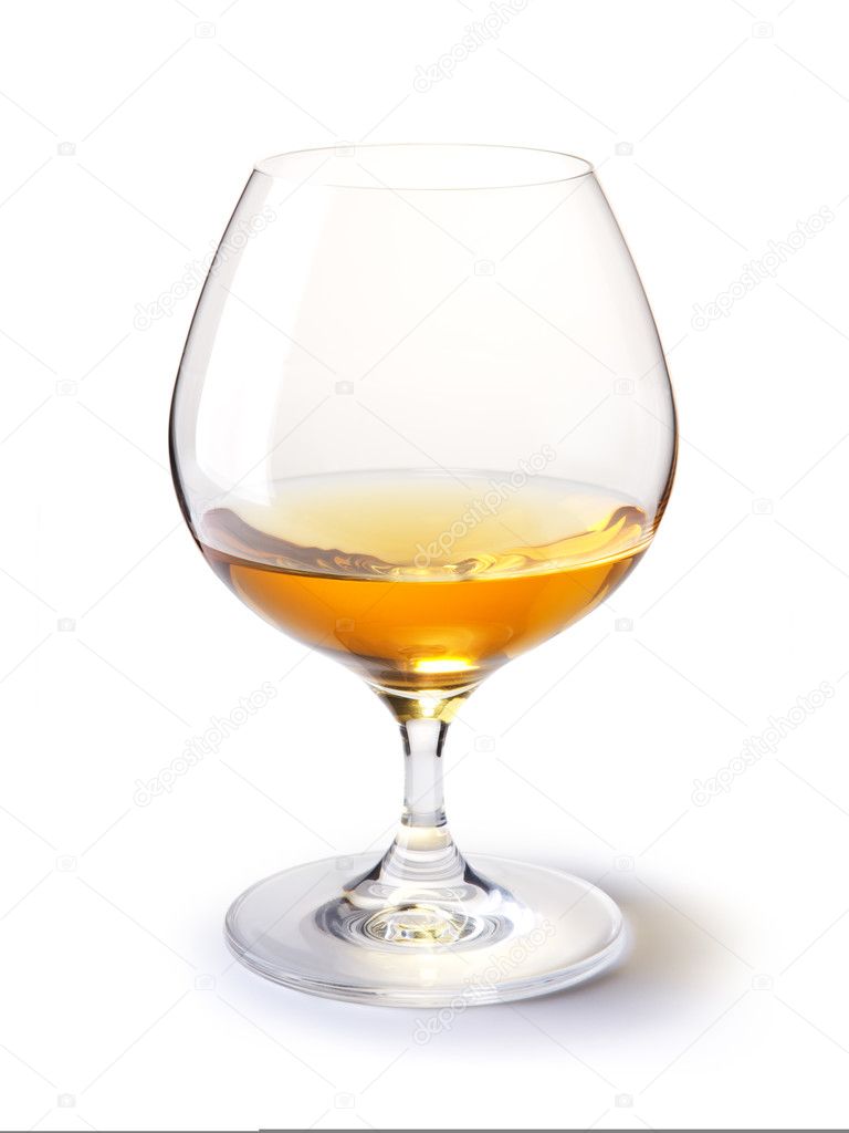 Cognac glass with gold cognac on a white