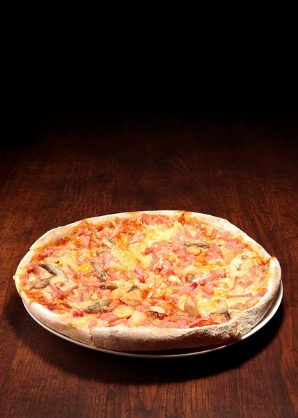 stock image Pizza on a wooden table