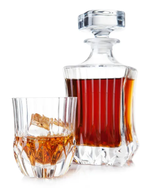 Glass and decanter of brandy on a white — Stock Photo, Image