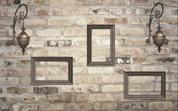 Frames and lanterns on the brick wall — Stock Photo, Image