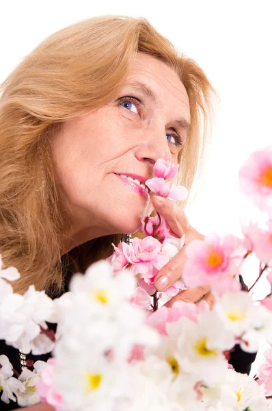 Happy old woman with flowers — Stock Photo, Image