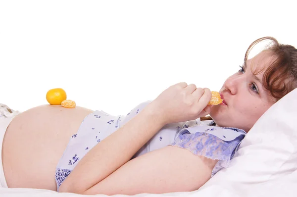 Pregnant woman with mandarin — Stock Photo, Image