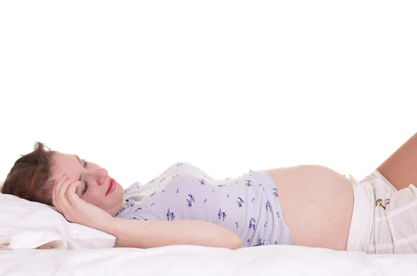 Pregnant woman at bed — Stockfoto