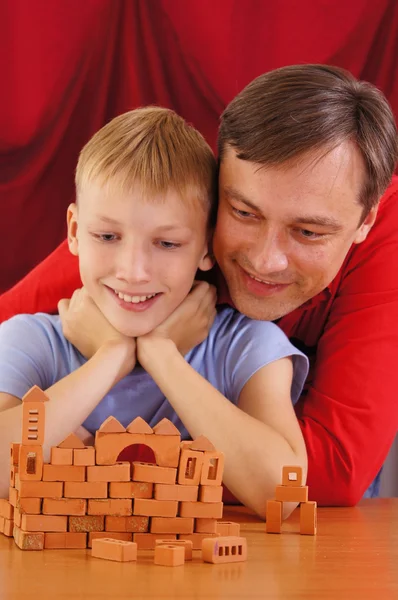 Dad and son on red — Stock Photo, Image