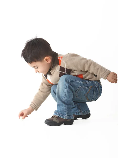 Schattig kind in studio crouching — Stockfoto