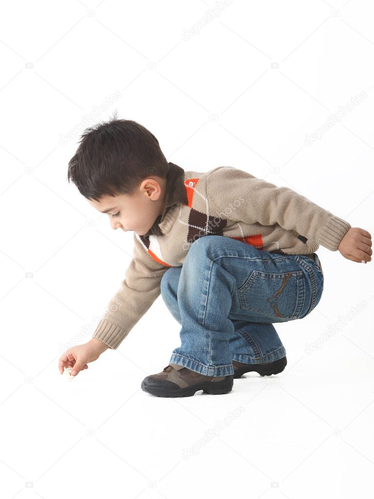 Adorable child in studio crouching