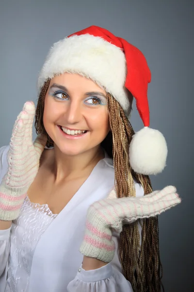 The young girl in the Christmas cap and mittens — Stock Photo, Image