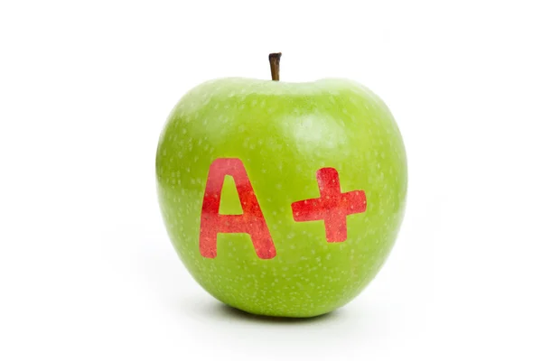 Groene appel en een plusteken (+) — Stockfoto