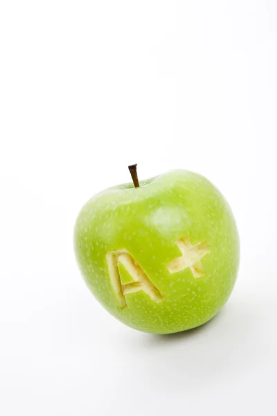 Zelené jablko a znaménko plus — Stock fotografie
