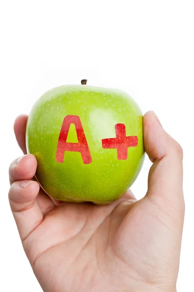 Зеленое яблоко и знак A Plus — стоковое фото