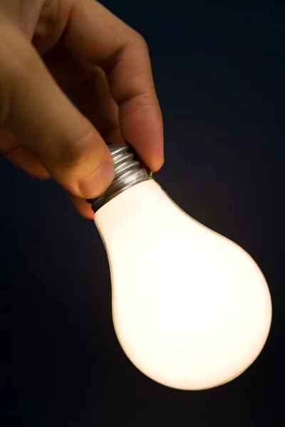 Hand holding a Bright Light Bulb — Stock Photo, Image