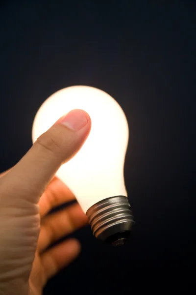 Hand holding a Bright Light Bulb Stock Picture