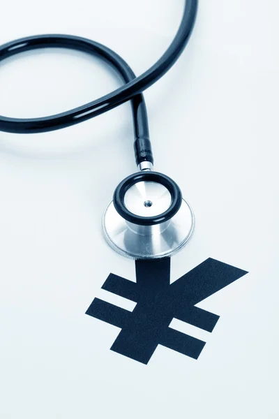 Stethoscope and Yuan sign — Stock Photo, Image