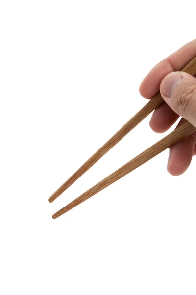 Hand som håller ett par ätpinnar — Stockfoto