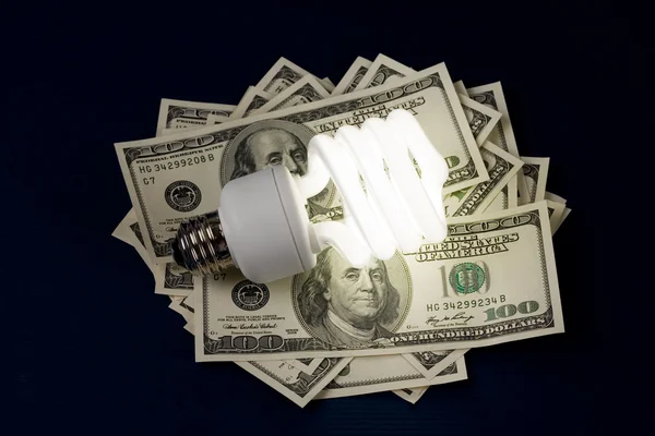 Lâmpada fluorescente compacta e dólar — Fotografia de Stock