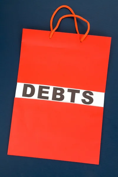 Shopping Bag and word debts — Stock Photo, Image