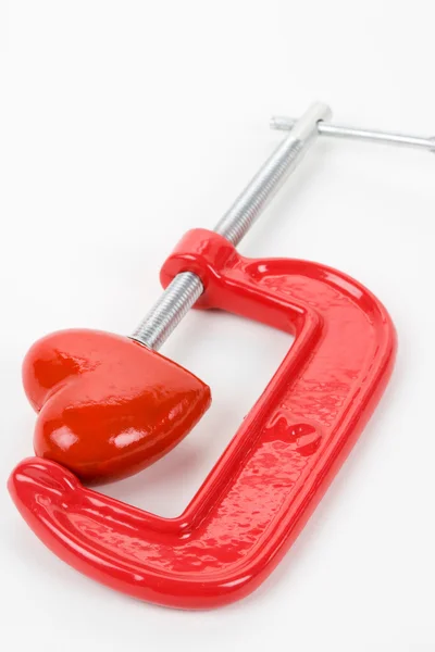 Stisk svěráku a červené srdce — Stock fotografie