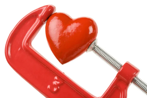 Stisk svěráku a červené srdce — Stock fotografie