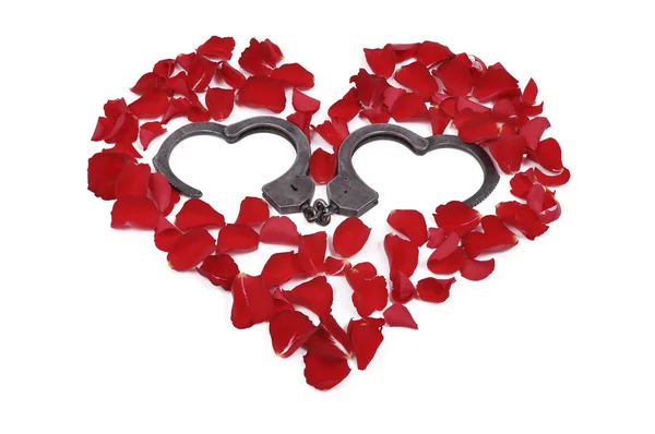 Heart made of roses with handcuffs inside — Stock Photo, Image