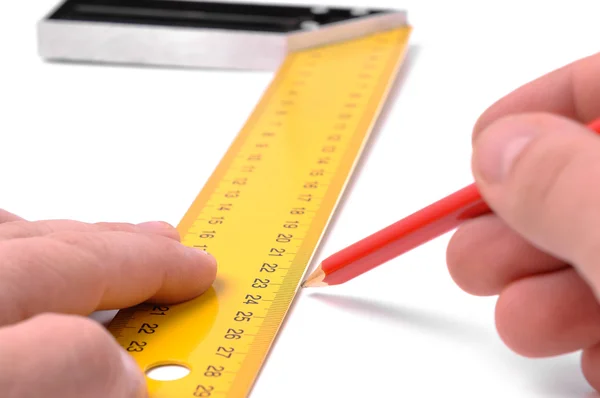 stock image Hands with pencil and metal angle