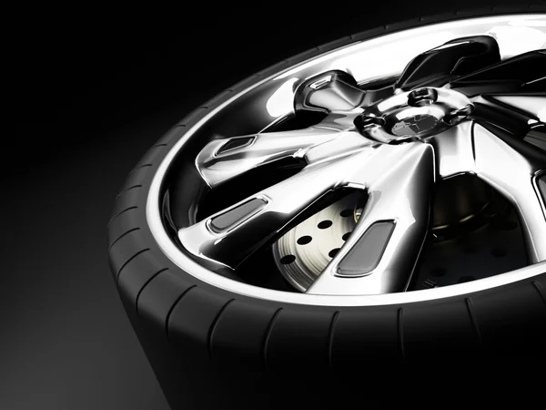 Car wheel on a black background — Stock Photo, Image