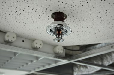 Installation of a fire sprinkler clipart