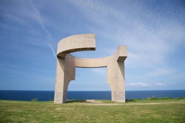 Cement monument over Gijon coast clipart