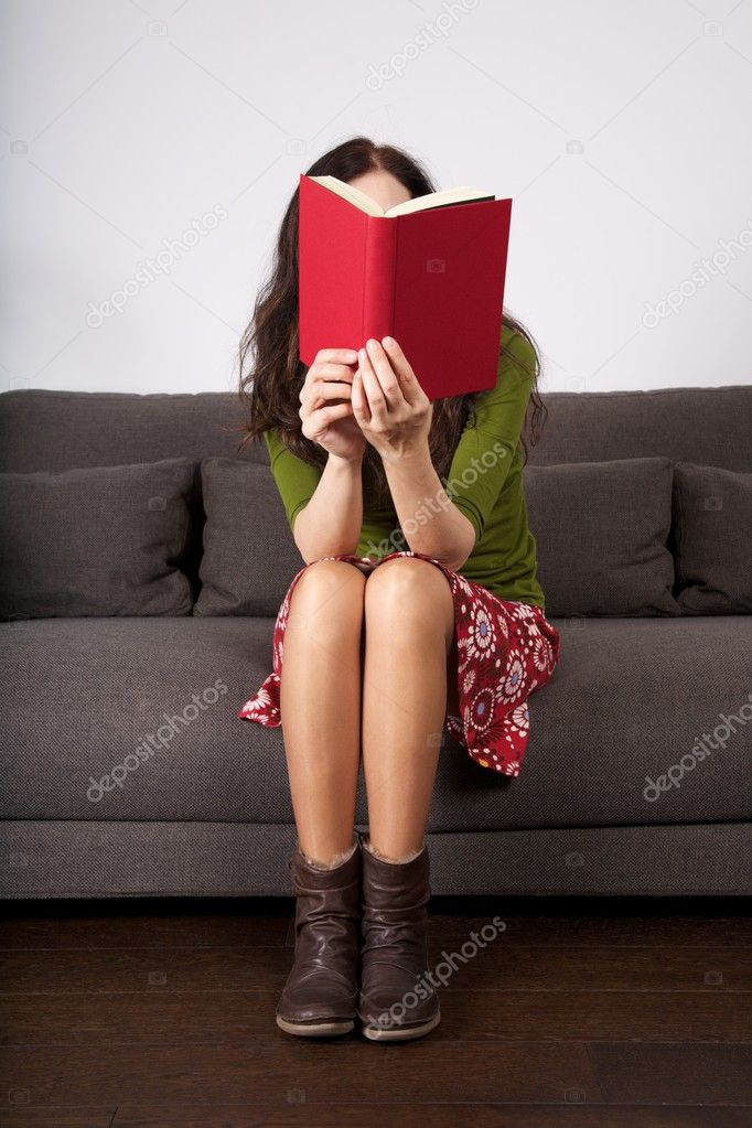 Red book on sitting woman face
