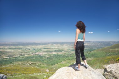 Stand woman looking at Piedrahita village clipart