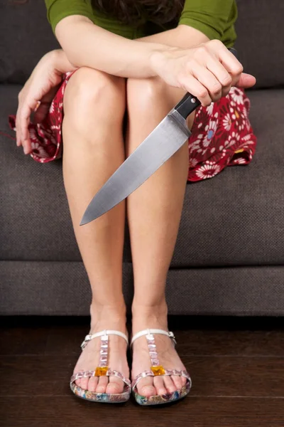 Velký nůž v ženu sedící ruce — Stock fotografie