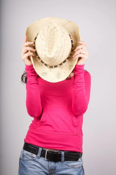 Pink lady hidding her face with straw hat — Stock Photo, Image