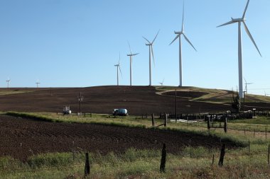 Wind energy turbines and farmland. clipart