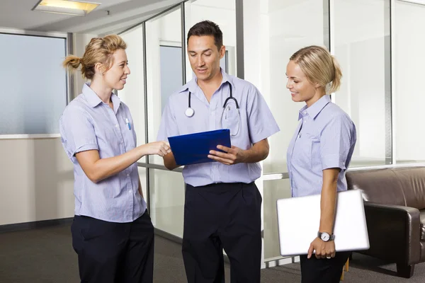 stock image Young doctor with two nurses