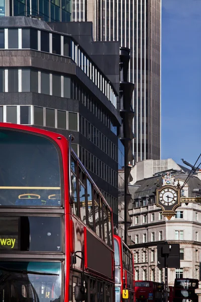 Red bus in London with office building — Stock Photo, Image
