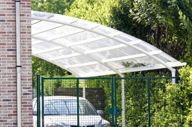 Carport in white with iron pipes and plexiglass clipart