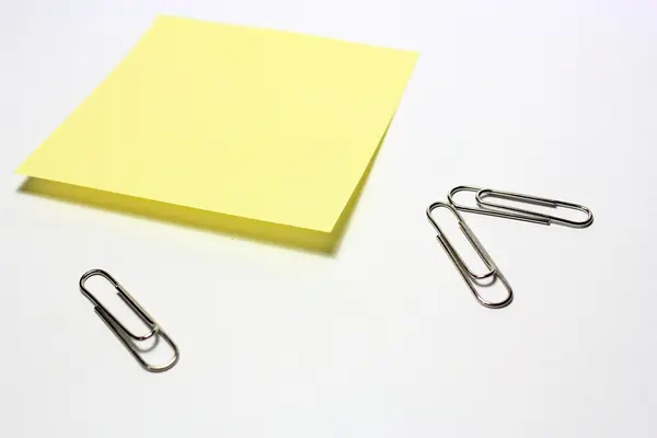 stock image Yellow note with clip on white background