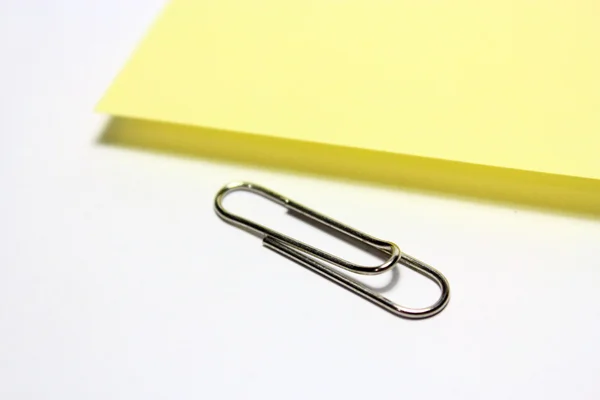 stock image Yellow note with clip on white background