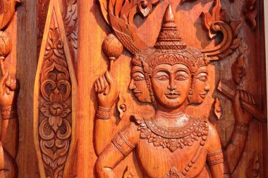 Native Thai style carving, painting on church door in the temple clipart