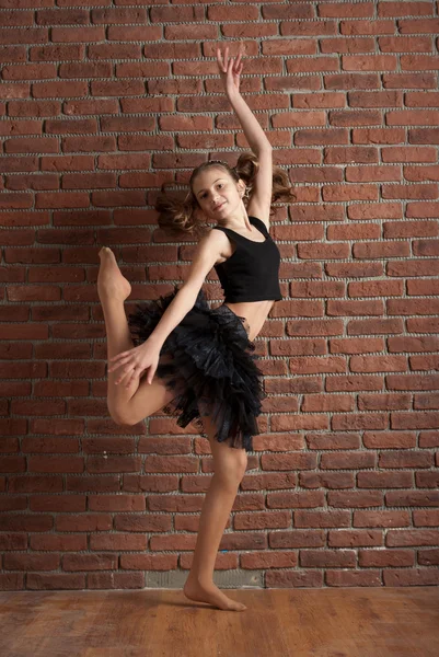 Κορίτσι χορό κοντά σε τοίχο από τούβλα — Φωτογραφία Αρχείου