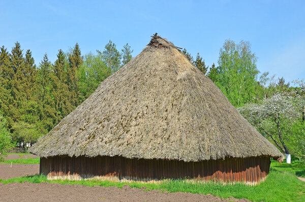 Ancient traditional ukrainian rural barn with a straw roof
