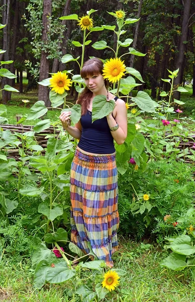 Girl between sunflower — Stock Photo, Image