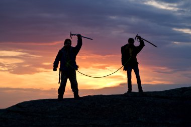 Silhouette of two person in mountain clipart