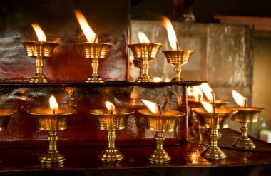 Burning candles in the Buddhist temple clipart