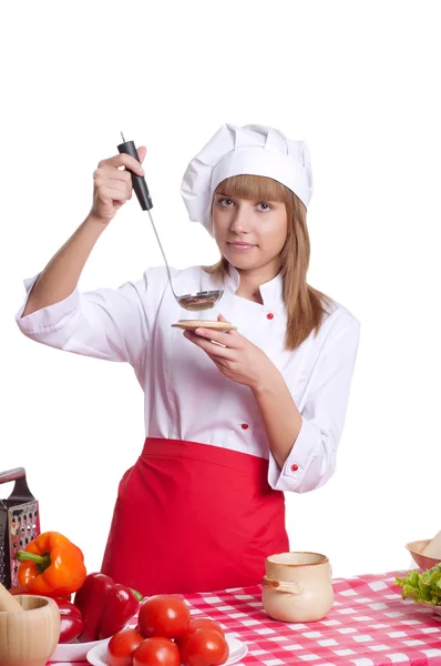 Atractiva mujer cocinera un fondo sobre blanco — Foto de Stock