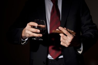 Rich person, holds a cigar and whisky clipart