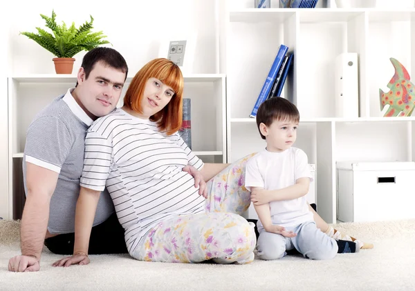 Madre incinta, padre e bambino, arredamento domestico — Foto Stock