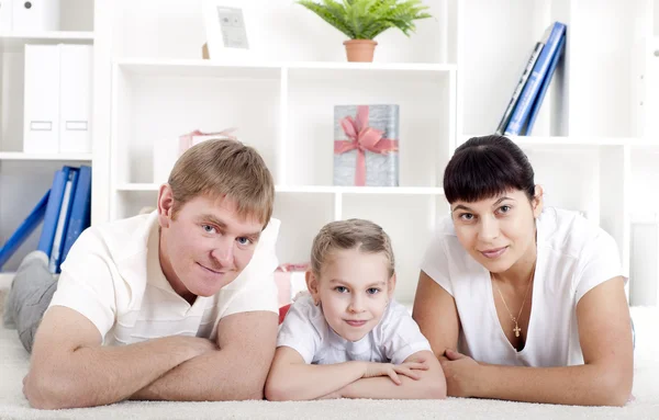 Portrait of happy family lying together, hugging and happy — Stock Photo, Image