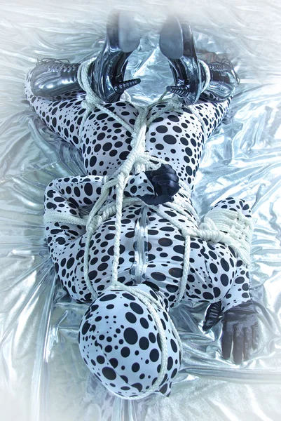 Fetish model in polka dots latex tied with rope — Stock Photo, Image