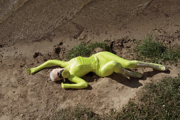 Heldere spandex catsuit meisje met gasmasker op het strand — Stockfoto